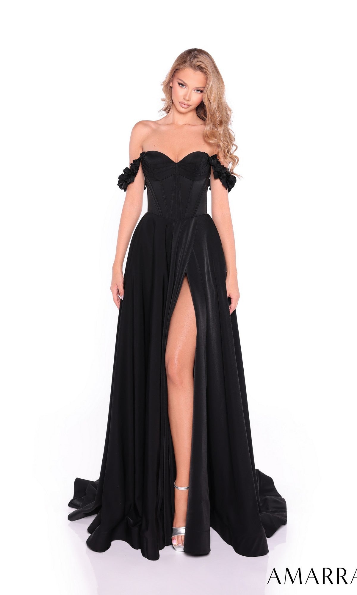 A woman stands against a white background wearing the Amarra 89441, a long satin prom dress with an off-the-shoulder neckline, corset bodice, and high slit.